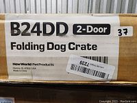 Box label showing product model B24DD, double door folding dog crate by New World Pet Products.