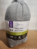 Photo of packaged fitted sheet showing size and brand label