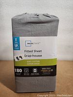Photo of Mainstays fitted sheet packaging showing brand, size, and material details