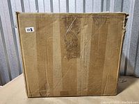 Photo of closed cardboard box containing the car air bed inflatable mattress