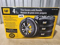 Box of 4 CAT tire covers with handles, showing product features and fitment info