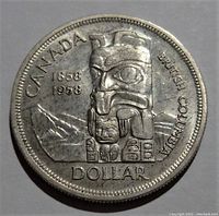 Obverse side of 1958 Silver Canada $1 Dollar coin showing totem pole design, dates 1858-1958, and inscriptions including 'CANADA' and 'BRITISH COLUMBIA'.