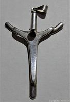 Front view of silver custom crucifix pendant showing overall design, surface texture, and bail for chain attachment.