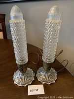 Pair of antique glass desk lamps showing textured bubble glass columns and scalloped bases.