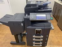 Full view of the Kyocera TASKalfa 420i multifunction office device including paper trays and document finisher.