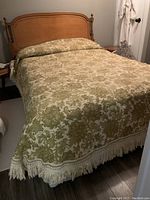 Full view of the vintage cotton bedspread fitting a double bed on a wooden frame.