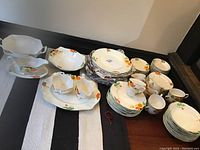 Overview of all dinnerware and serveware laid out on table