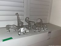 Group shot of all seven figurines on a shelf