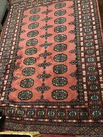 Full view of rug on wood floor showing overall pattern and color.