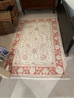 Full view of the rug laid on floor showing overall pattern and coloration