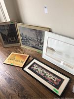 Five artworks are laid on the floor, including the three from the lot along with extra pieces for context. One frame is noticeably damaged.