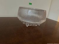 Side view of the Iittala glass bowl showing the textured upper glass and bubble-like pattern on the base.