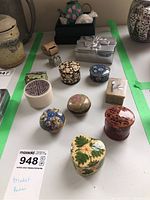 Overview of 10 assorted trinket boxes showing various shapes, colors, and materials including enamel, pottery, pewter, and carved lacquer.
