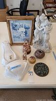 Photo showing the full lot with statue, clock, various small vases, figurines, and wall decoration.