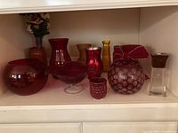 Wide view of the vases and containers arranged against white shelving