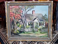 Full view of the oil painting and its period wood frame, showing cottage scene and frame wear.
