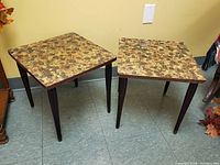 Two small mid century end tables side by side, showing top pattern and legs