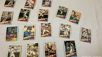 Photo showing multiple New York Mets player baseball cards laid out, including players like Edgardo Alfonzo, Doug Sisk, Ed Lynch, and others.