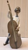 Front view showing the boy holding double bass, detailed facial features and instrument shape visible