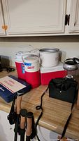 Photo of coolers, propane stove, and camping lanterns