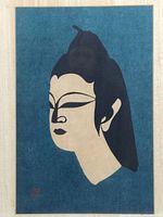 Front view of the framed woodblock print showing the Buddha profile with blue background, cream face, and black hair.