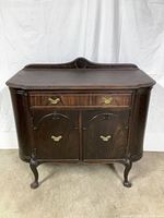 Front view of Limberts Arts & Crafts buffet showing drawer, cabinet doors, and carved back panel detail on top.