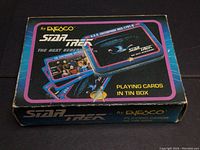 Closed box of Star Trek The Next Generation playing cards in tin by Enesco showing USS Enterprise NCC-1701-D art and Star Trek branding.
