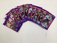 Twelve unopened sealed trading card packs from 1993 featuring The Beatles, arranged in a fan spread.
