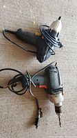 Top view of both tools: Black & Decker DR600 drill and Mastercraft impact driver with cords coiled