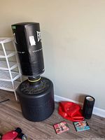 Main shot showing punching bag, gloves, roller, exercise ball and DVDs on floor