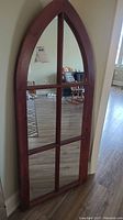 Full view of the Gothic style wooden wall mirror with pointed arch top and divided panes