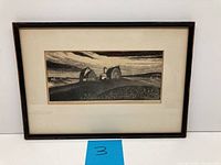 Framed 20th century black and white etching showing countryside farms and fields.