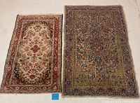 Two vintage Persian rugs side by side showing full view and relative sizes