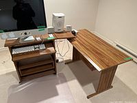 View of the two-part desk setup with computer and speakers to illustrate desk dimensions and features.