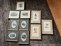 Overview of all nine framed antique prints arranged on floor showing different sizes and subjects including landscapes and military figures.