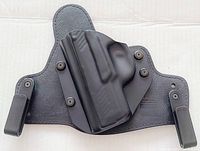 Full view of the left-hand Alien Gear Cloak Tuck holster showing molded black Kydex shell attached to textured leather backer with belt clips.