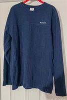 Front view of navy blue Columbia sweatshirt, showing overall color and design with long sleeves and crew neck.