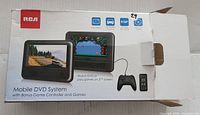 Box of RCA Mobile DVD System showing screen and controller images with branding and features