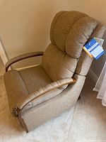 Side view of beige recliner showing overall condition and design