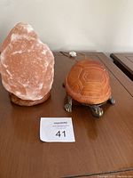 Photo showing salt lamp and turtle lamp on table with MaxSold lot number