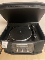Open view of TEAC stereo system showing built-in turntable with lid raised