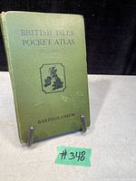 Front cover of the green hardcover book titled British Isles Pocket Atlas by Bartholomew.
