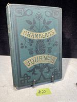 Front cover of the antique book 'Chambers's Journal' showing decorative embossing in green cloth binding with gold and black title