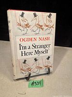 Front cover of the antique book showing title, author, and illustrated dust jacket with birds wearing top hats.