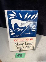 Front of book showing blue and white dust jacket with bird design and title.