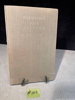 Front cover of the book with title "Painting As A Pastime" by Winston Churchill, beige cloth cover showing some age wear.