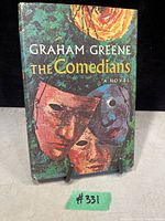 Front cover of the book with colorful artistic mask design and title text.