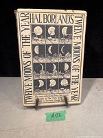 Front cover of the vintage book showing title, moon phase illustrations, and normal age wear.