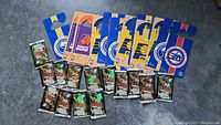 Photo showing unopened Michael Jordan Milk Caps packs and six wooden NBA door hangers with various team logos and colors.