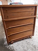 Full front view of walnut tall boy dresser